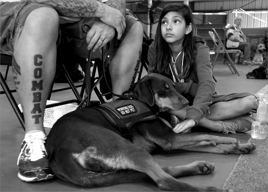 Carlos Vera, his daughter, and service dog Ruthie. Families are encouraged to join in the veteran/service dog training program so that they all can participate in the healing journey.  