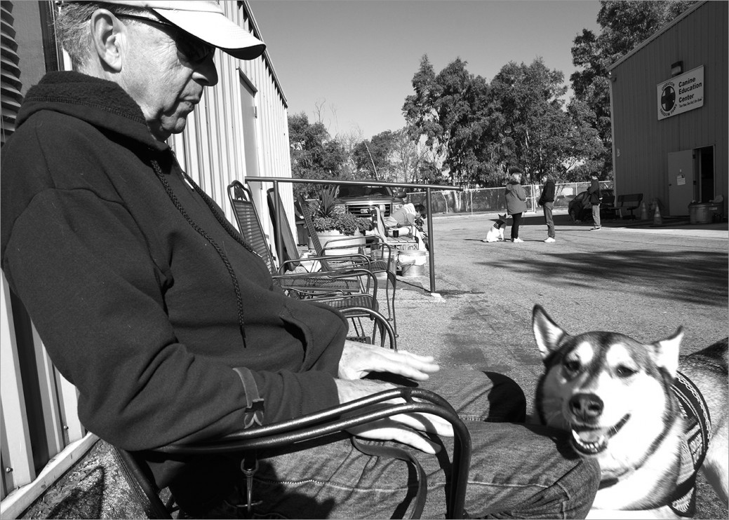 On a break at training class, Vietnam Veteran Marv Lewis rests with his service dog Kairu by his side. “Kairu helps me in a lot of ways. Sometimes she’ll jump on my lap if she knows I’m depressed. I have a hearing loss from a shelling gone bad so I can’t hear somebody coming in the house but she alerts me by her reaction.”  